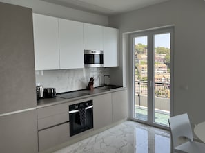 Fully equipped kitchen with a door to the terrace