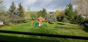 Backyard with swingset and river