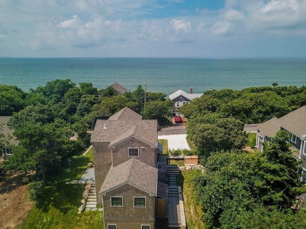 Drone view of home with bay in the distance