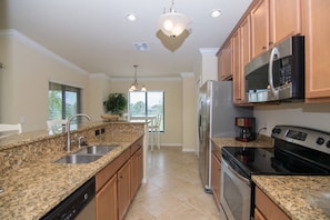 The Kitchen Features Granite Counters and a Bar Height Counter