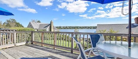 porch overlooking cove with table, chairs and umbrella