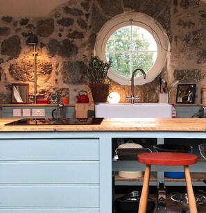 Open plan social kitchen with views through the round window