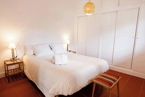 The bedroom is bathed in natural light, creating a serene atmosphere to recharge.