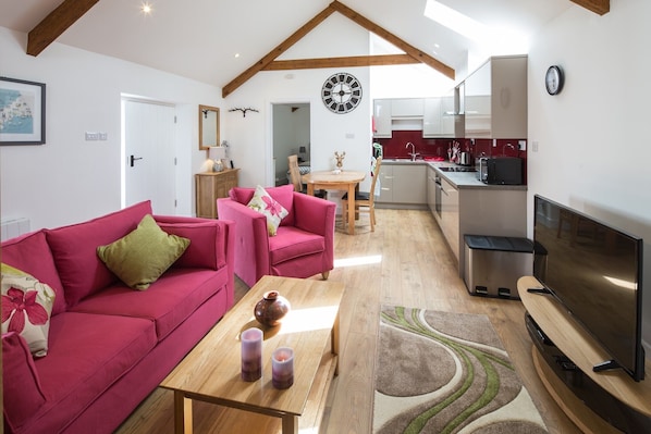 A large living area with Smart TV and generous dining and kitchen area