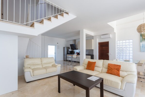 Spacious and bright living room with the kitchen on the back