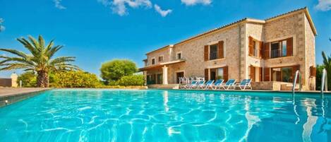 Swimming pool and sun loungers