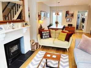 Front room with cosy wood burning stove for colder months. 