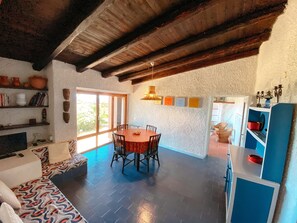 The living room adjacent to the patio and the kitchen