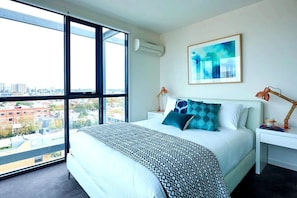 Colourful master bedroom with queen bed