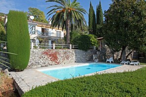 Heated pool with Magnolia tree, main Building behind