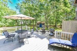 rear deck with chaise lounge, table, chairs and umbrella