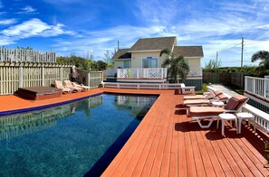 Three identical villas surrounding pool, hot tub, sun deck and fire pit.