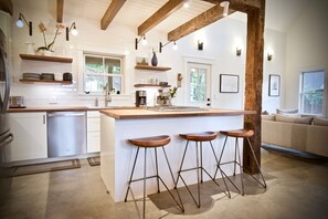 Open-plan kitchen with open-joist ceiling.