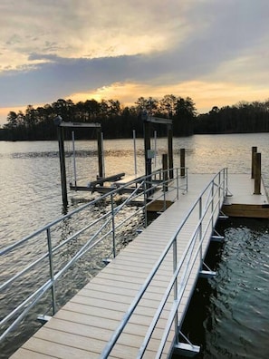 Ramp to floater, sunrise view.  Boat lift is for owners use only however you are welcome to tie your boat up to the dock.