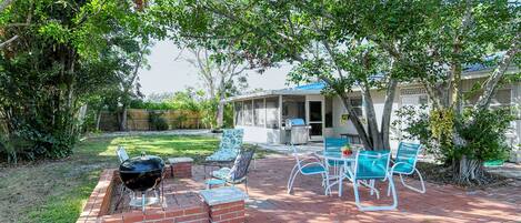 Totally fenced 110'x40' backyard with shaded conversation and dining areas. 