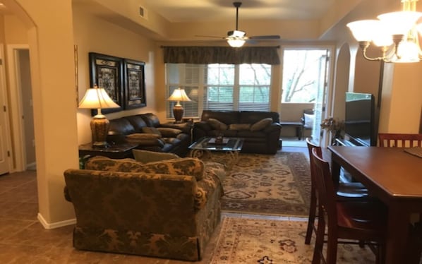 Overview from entry hall looking at living room, dining room to private deck.