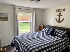 Queen bed with Roku streaming TV.