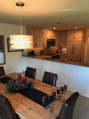 Dining Table looking into Kitchen. Bar Seating for 4 people