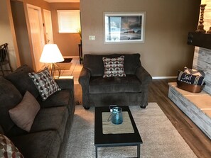 View into living room from sliding patio door onto deck