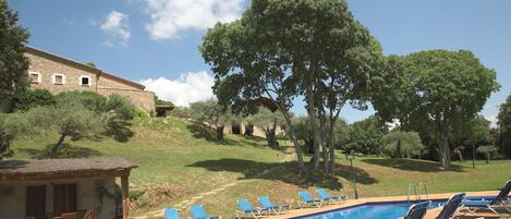 Large pool, with poolhouse w WC & shower & sitting areas & shaded play areas..