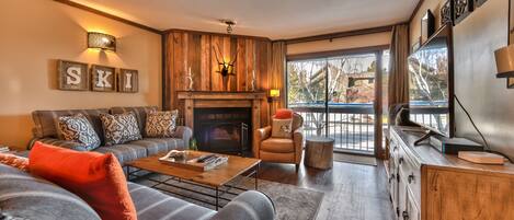 Living Room with Comfortable Mountain Contemporary Furnishings, Wood Fireplace and 47" Smart TV