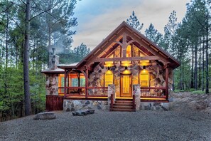 Cabin Front - Showing Covered Outdoor Fireplace and Hot Tub Area