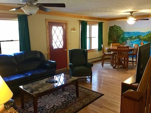 Large living room with Dish TV and card table