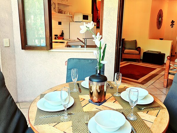 Outdoor dining on your private balcony overlooking the pool.