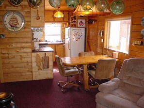 Kitchen and dinning table. The table pulls out  4th chair located in living room