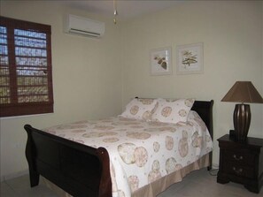 Queen size bed with A/C and ceiling fan