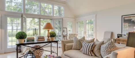 Living room with two sets of french doors to porch and water view!