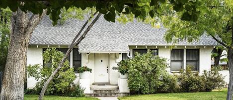 Bungalow style home with large trees