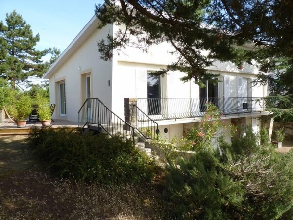 General view, façade, wooden terrace, tree-filled garden, south west exposition.