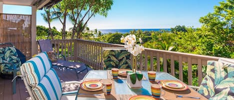 Enjoy quiet outdoor dining with partial ocean views on your private lanai