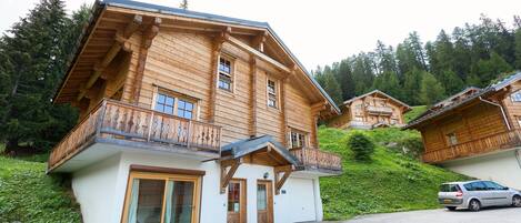 The chalet is built in a traditional style, featuring wood and stone design.