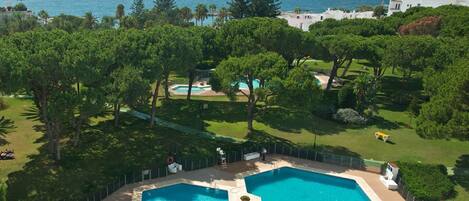Partial aerial view of Club Playas Del Duque gardens and beach. 