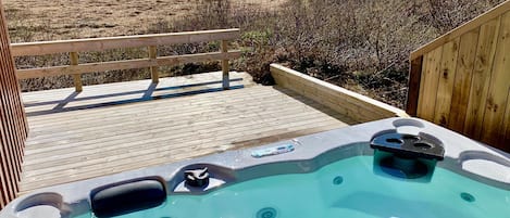 Hot tub on the patio with gorgeous view of majestic mountains.