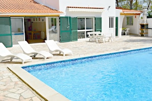 Pool area showing part of house with alpendre for outside covered eating