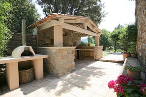 Outdoor Kitchen at Bastide 1 with BBQ, pizza oven, sink and full sized prep area