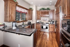 Chefs kitchen, with all cooking utensils, pots and pans, granite countertops