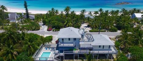 Aerial view of Salty Dolphin House, formerly Richview House, a private estate home with a heated pool directly across the street from world-famous French Leave House.