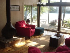 The living room sits in the front of the cabin, right on the water.