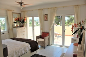 The upstairs master bedroom looking out onto its own private sun balcony