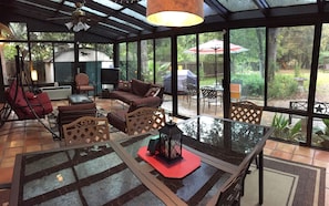 Sunroom with large dinning table and extra seating for your enjoyment. ac/heated