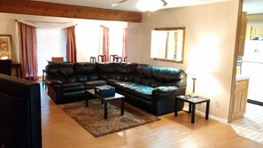 living room with sectional sofa and  pull out full size bed. Large 75" TV.