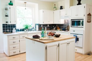 Spacious, well stocked cook’s kitchen will delight guests with beautiful views.