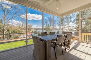 Screened in porch off of the great room over looking the lake