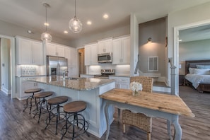 Fully furnished kitchen over looking the great room, master on right