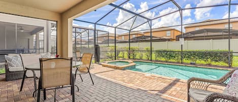 The house features a large private pool with a spa attached, perfect for a peaceful time after a long day at the parks. The fenced backyard provides privacy during your stay.