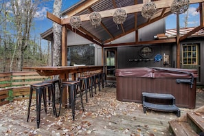 back deck, covered hot tub, bar and floating high table